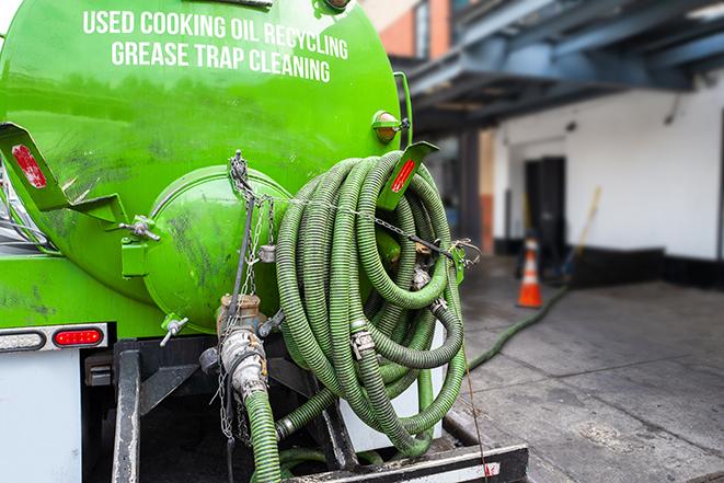 grease trap pumping truck in action in Arlington MA